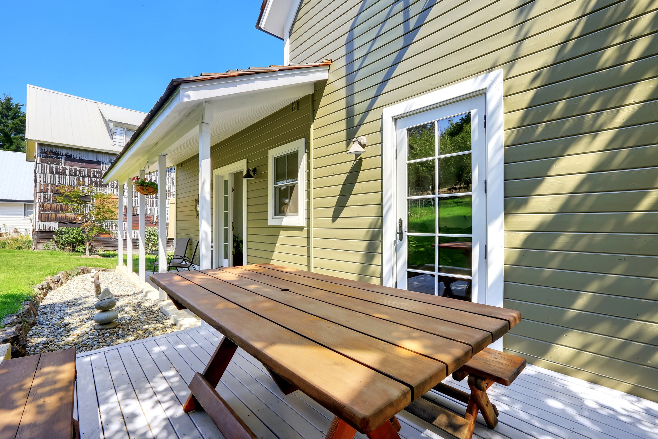 Green olive exterior paint of clapboard siding house